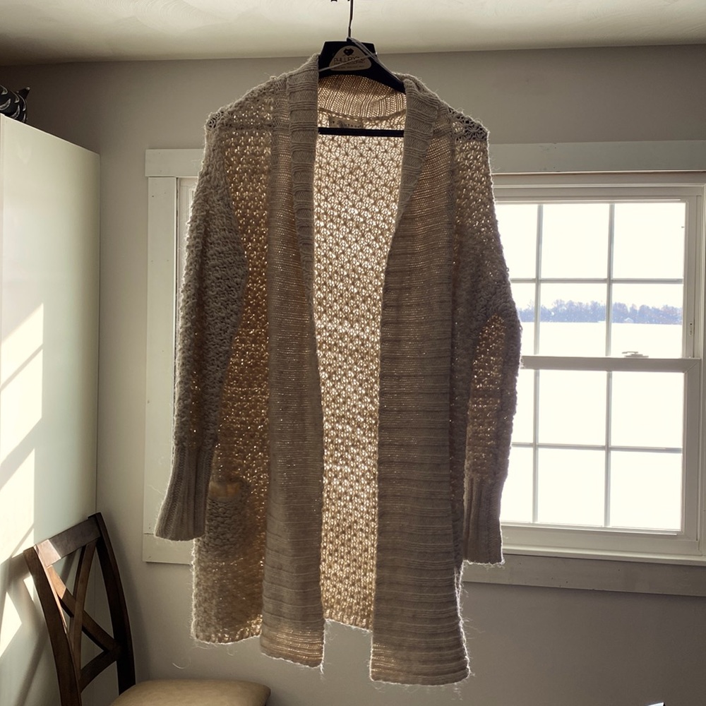 Knitted knee length wool sweater.